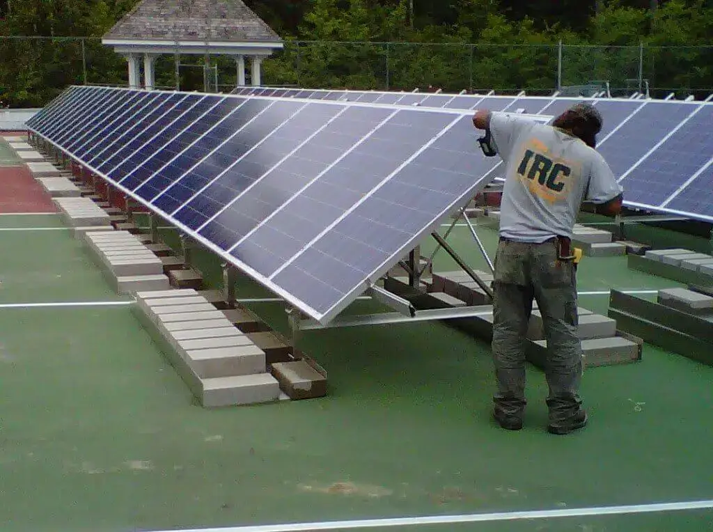 Technician performing maintenance on solar panels